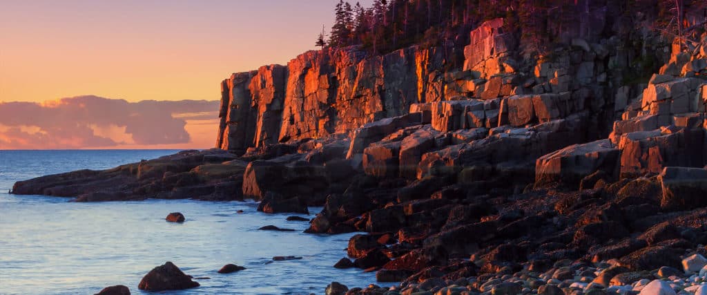The ocean meets the mountains in steps during sunset. Checklist