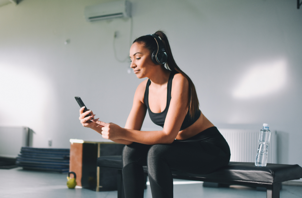 Women at the gym on her cell phone