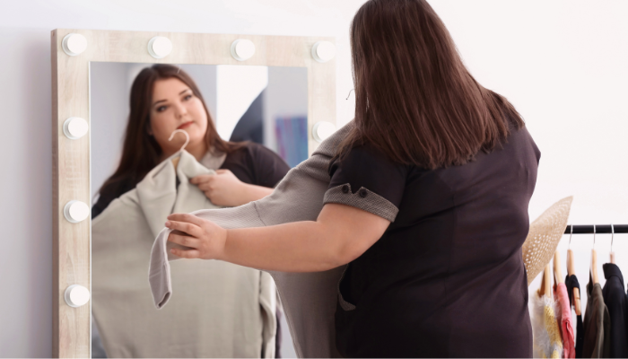A shopper evaluates different plus sizing and extended sizing apparel