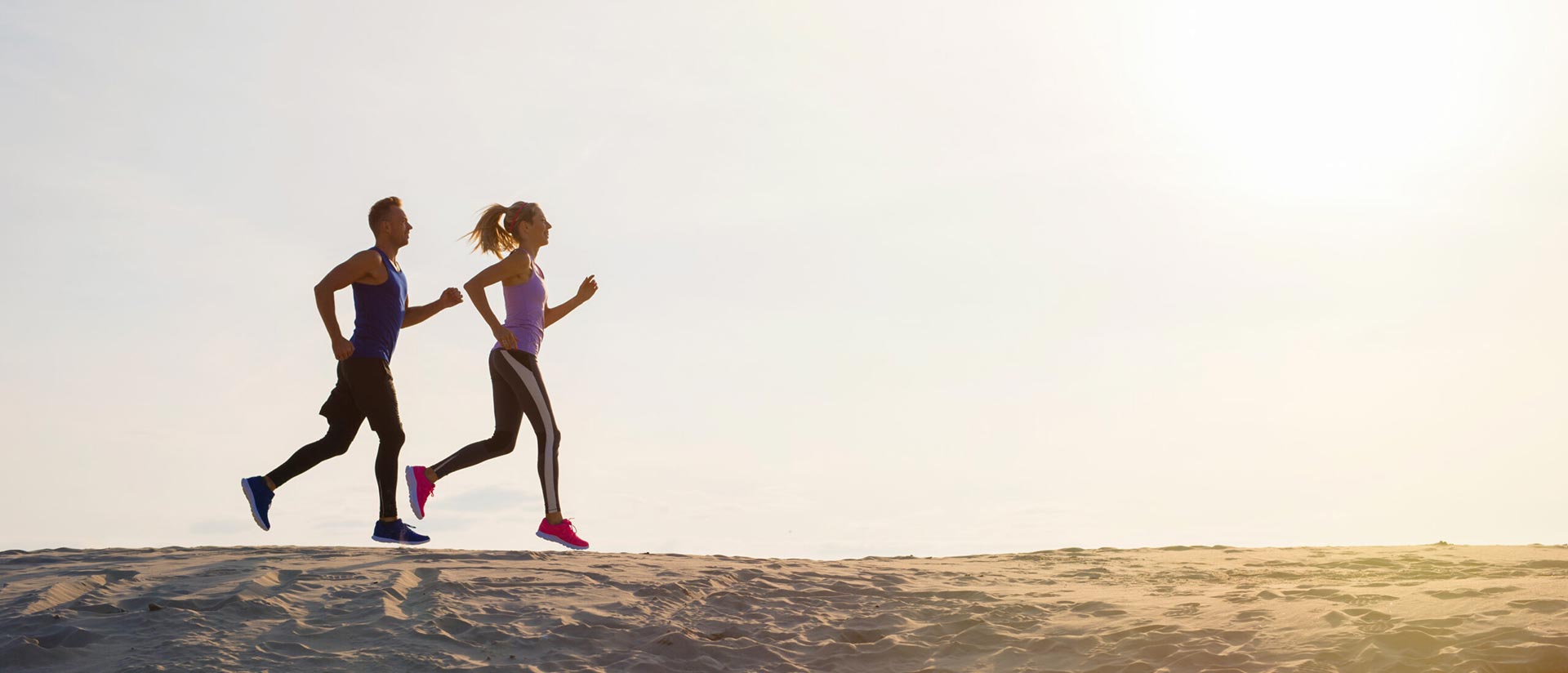 (testers running on a beach)