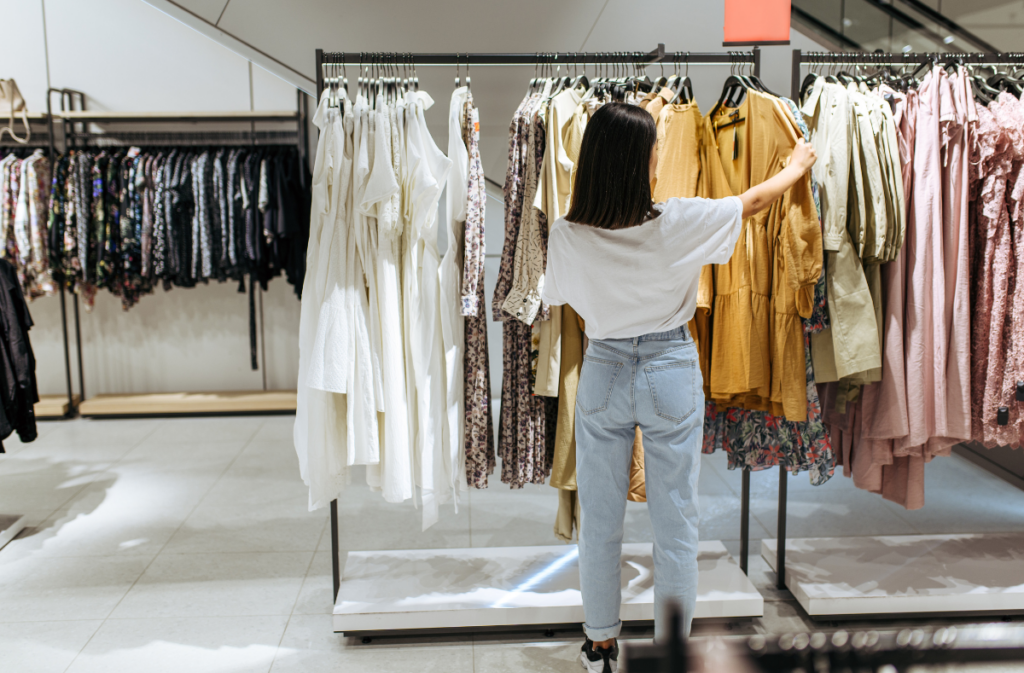 A customer selecting clothes from a rack.